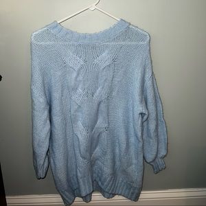 Women’s light blue knit sweater.